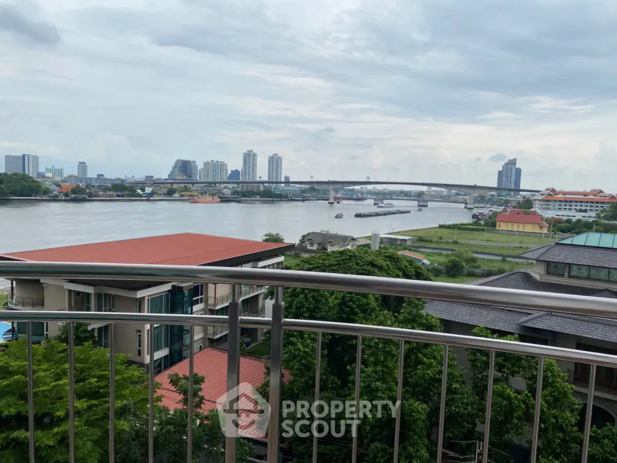 Stunning river view from balcony with city skyline and lush greenery.