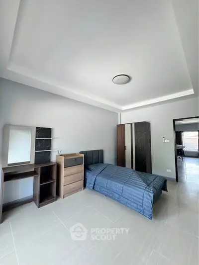 Spacious modern bedroom with sleek furniture and natural light