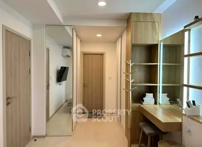 Modern study area with built-in wooden shelves and desk, bright lighting, and minimalist design.