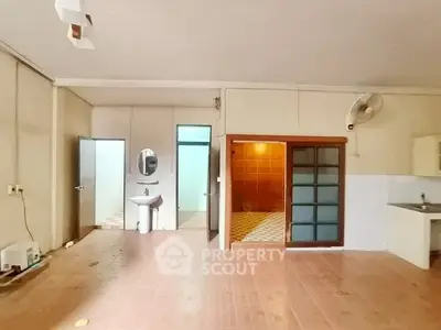 Spacious open-plan living area with wooden flooring and modern fixtures.