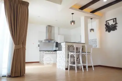 Spacious open-layout kitchen with modern design and breakfast bar