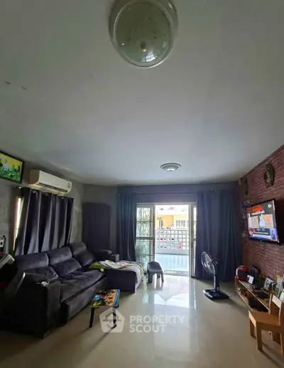 Spacious living room with modern decor and large windows for natural light.