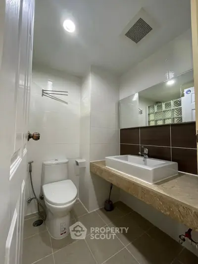 Modern bathroom with sleek fixtures and elegant tile design, perfect for a contemporary home.