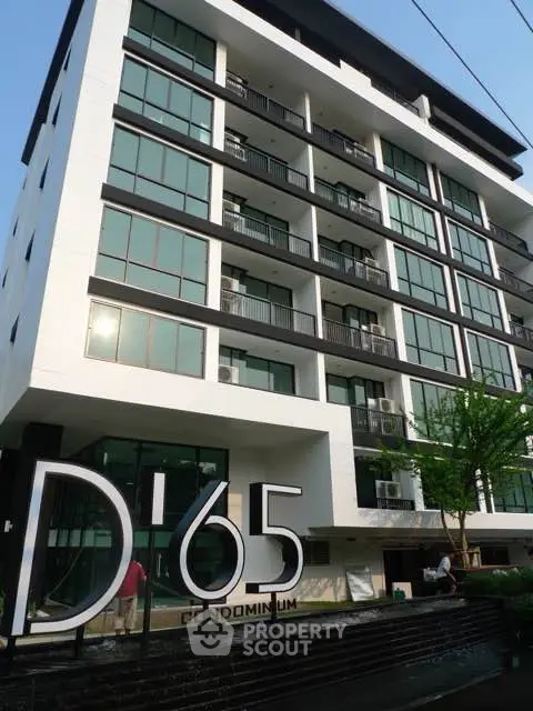 Modern condominium building with sleek design and large windows, ideal for urban living.