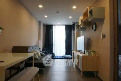 Modern living room with stylish furniture and natural light, perfect for relaxation and entertainment.