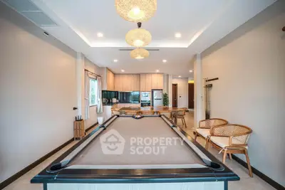 Spacious living room with pool table and modern kitchen in open layout design