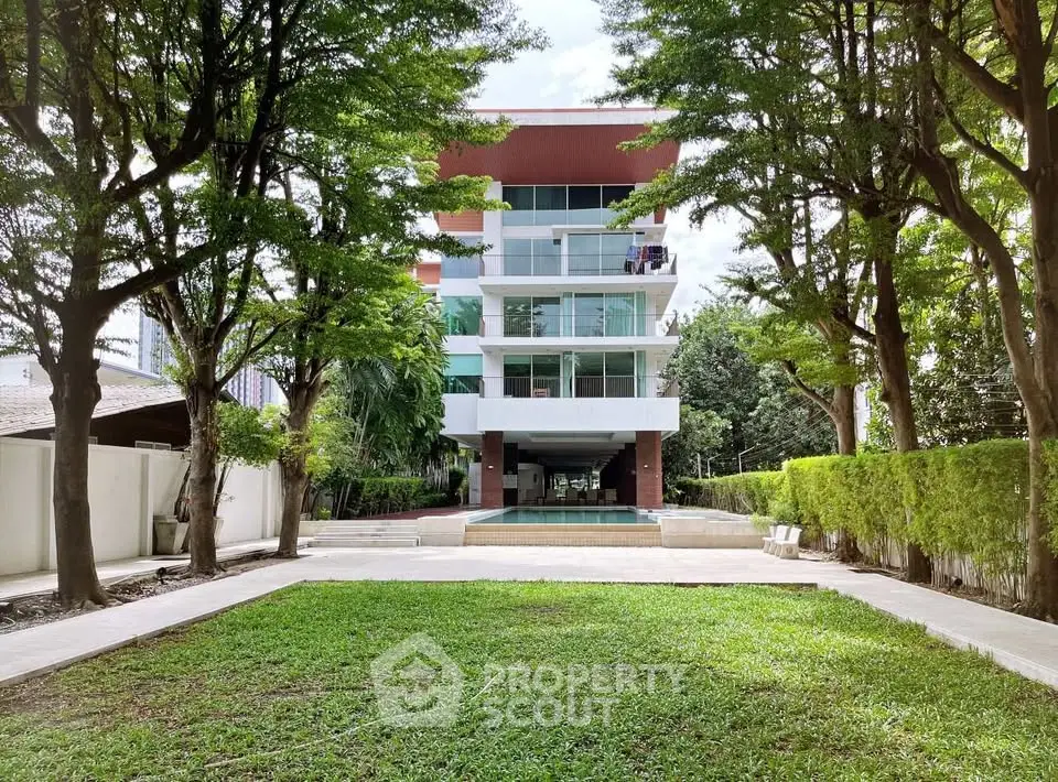 Modern apartment building with lush garden and spacious balconies