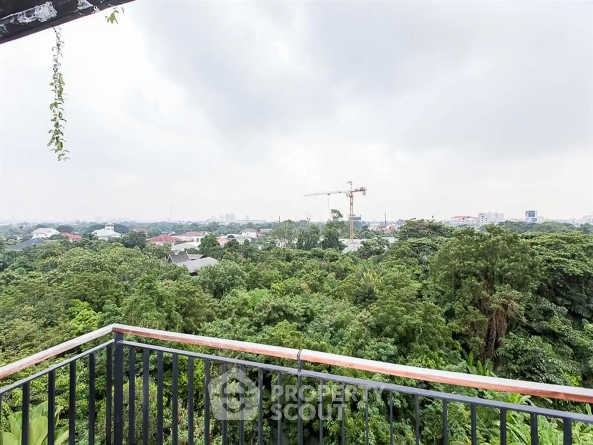 Stunning balcony view overlooking lush greenery and city skyline