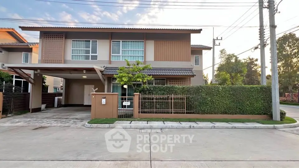 Modern two-story house with lush greenery and spacious driveway