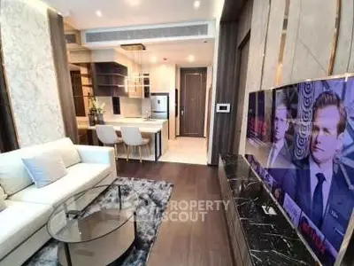 Luxurious modern living room with open kitchen, featuring elegant decor and high-end appliances.
