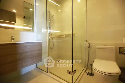 Modern bathroom with glass shower enclosure and sleek fixtures