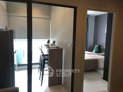 Modern apartment interior with cozy bedroom and dining area, featuring sleek design and natural light.
