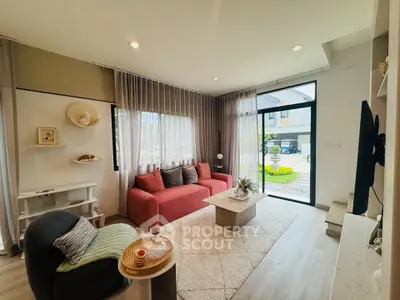 Charming living room with modern decor, large windows, and cozy seating in a bright, inviting space.