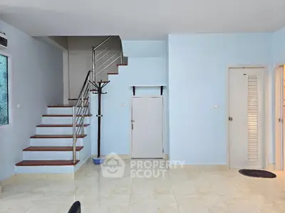 Modern interior with staircase and light blue walls in a spacious home