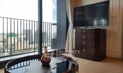 Modern living room with city view, large TV, and stylish furniture in high-rise apartment.