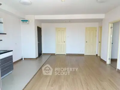 Spacious empty living room with wooden flooring and modern design