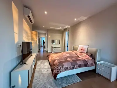 Spacious modern bedroom with stylish decor and natural light