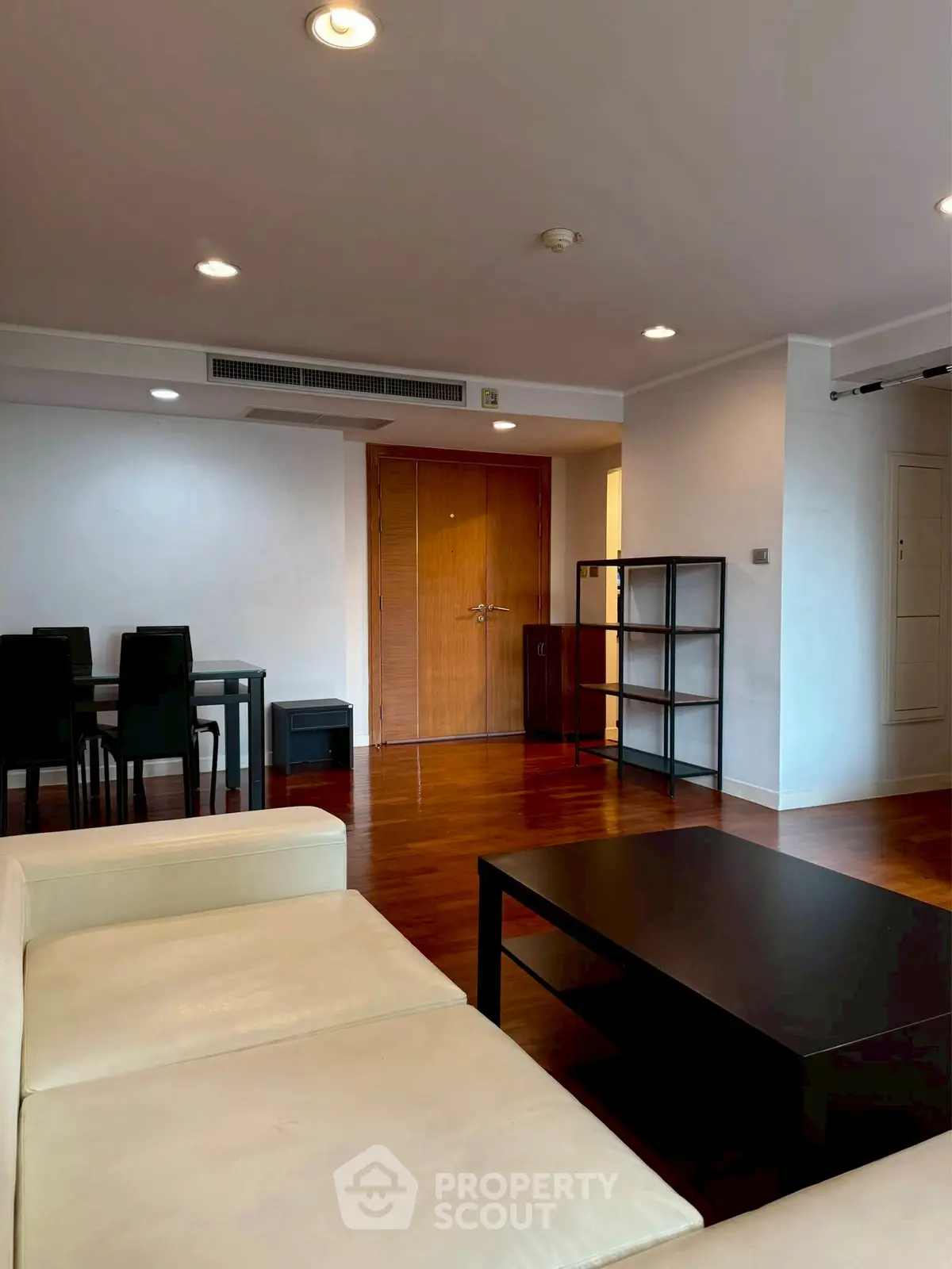Spacious modern living room with wooden flooring and elegant furniture