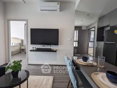 Modern open-plan living space with sleek furniture and integrated kitchen, perfect for entertaining and relaxed living, highlighted by natural light.