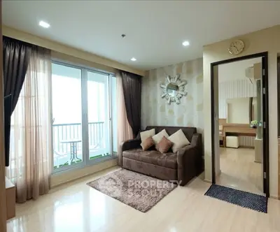 Spacious living room with elegant decor and balcony access in modern apartment.