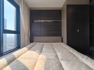 Modern bedroom with large window and stylish wooden wardrobe