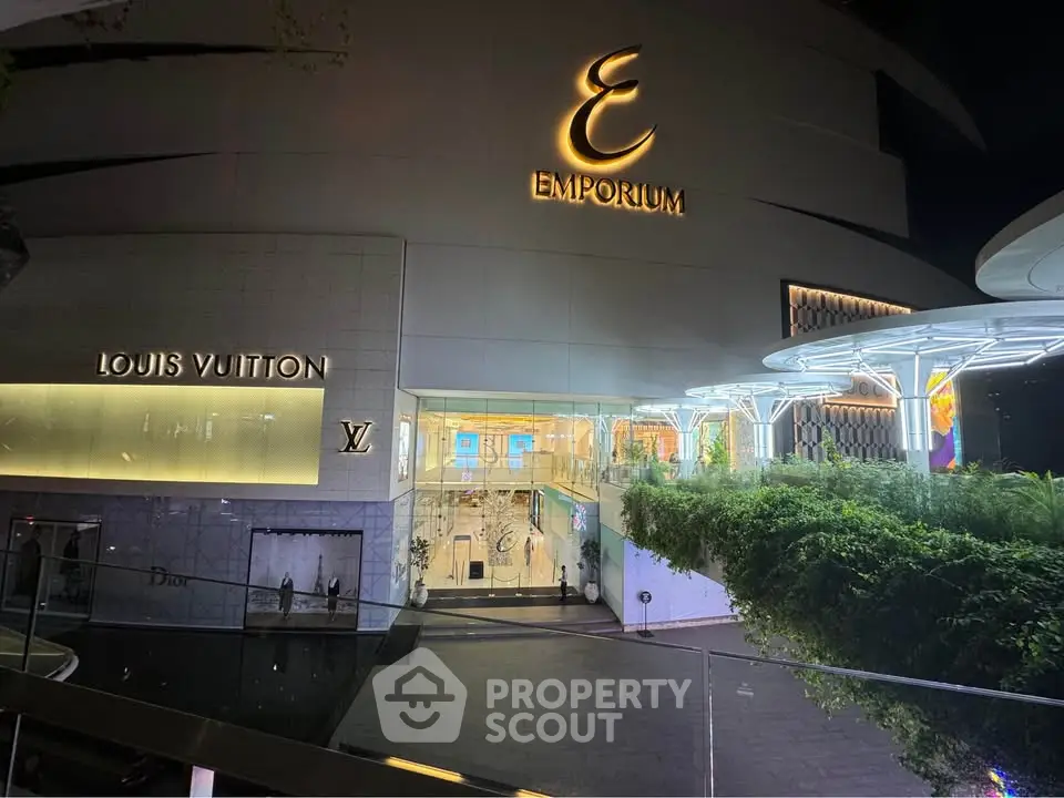 Luxurious shopping mall entrance with high-end brand stores and modern architecture.