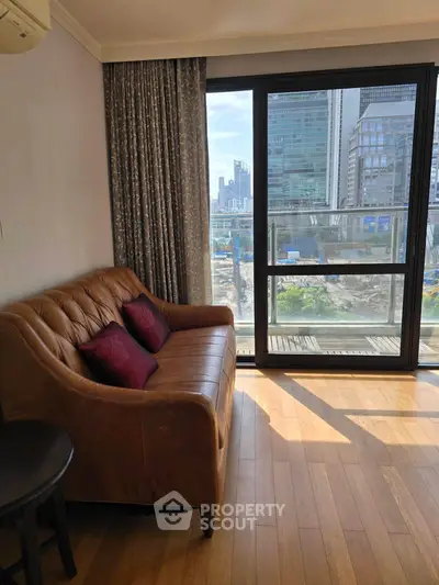 Stylish living room with leather sofa and city view from large window, perfect urban retreat.