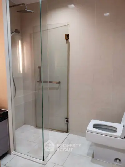 Modern bathroom with glass shower and sleek fixtures