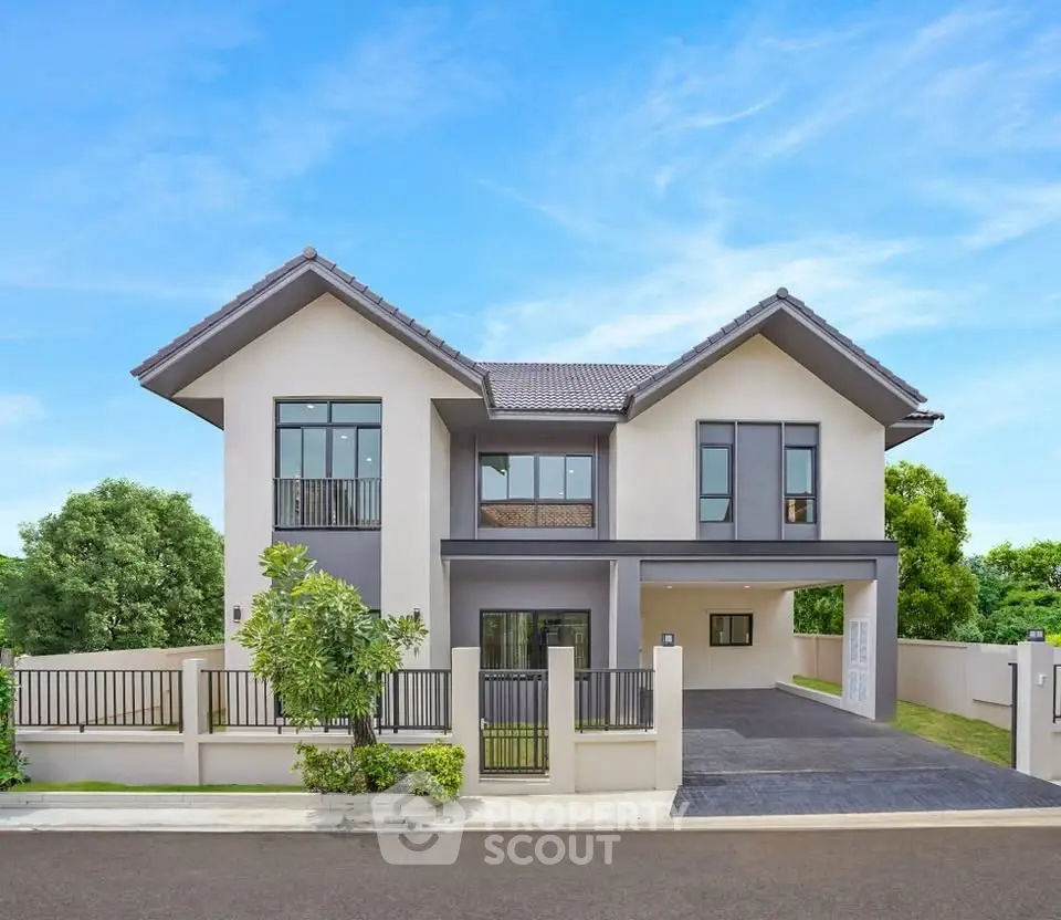 Modern two-story house with sleek design and spacious driveway in a serene neighborhood.