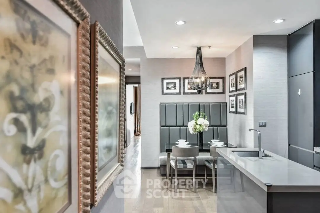 Modern kitchen with sleek design, featuring a cozy dining area and elegant lighting.