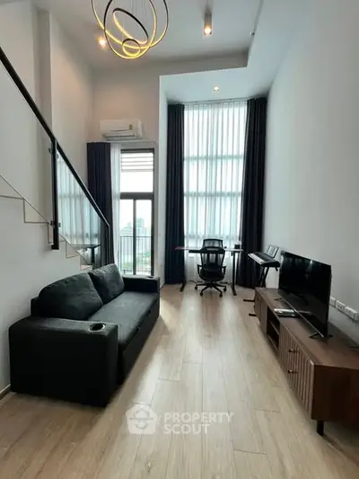 Modern loft living room with high ceilings and city view, featuring sleek furniture and stylish lighting.