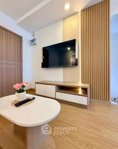 Modern living room with sleek TV setup and stylish wooden decor