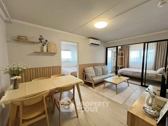 Charming open-plan living room with cozy dining area and modern decor