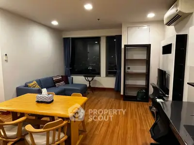 Spacious living room with modern furniture and city view, perfect for urban living.