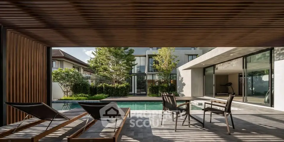 Luxurious modern home with poolside patio and sleek outdoor furniture, perfect for relaxation and entertainment.