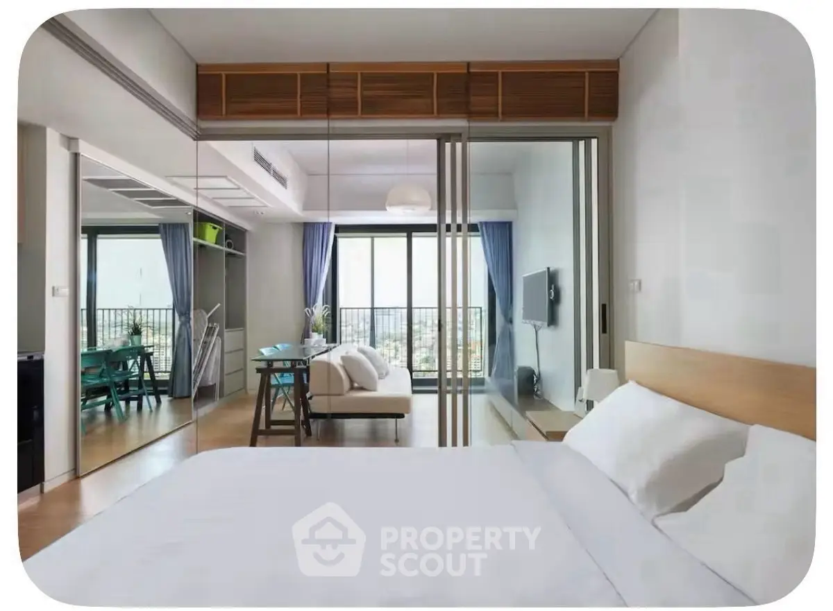 Modern bedroom with mirrored closet and balcony view in stylish apartment