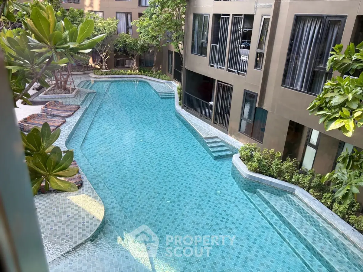 Luxurious residential pool area with modern design and lush greenery