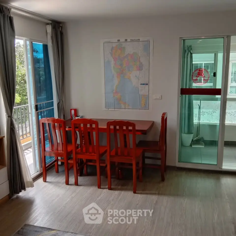 Charming dining area with natural light and balcony access in modern apartment.