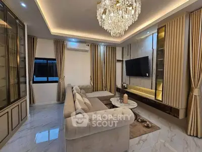 Luxurious living room with elegant chandelier and plush sofa, perfect for modern comfort and style.