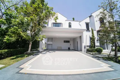 Stunning modern home with spacious driveway and lush greenery