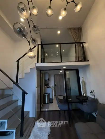 Modern loft apartment with stylish lighting and mezzanine level, featuring sleek staircase and contemporary decor.