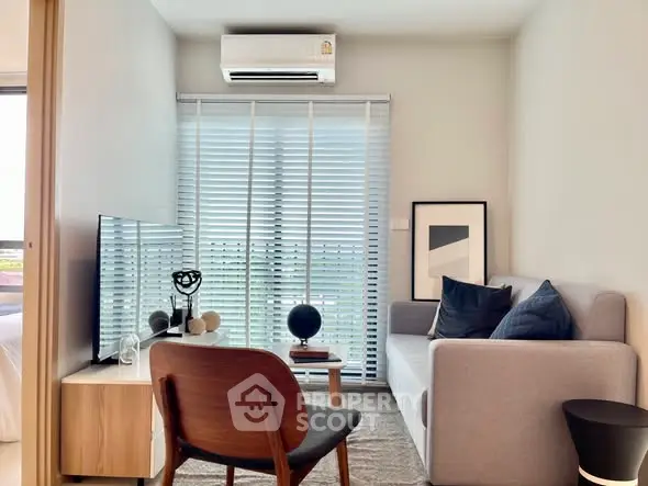 Modern living room with sleek furniture and natural light, perfect for urban living.