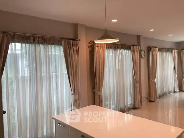 Elegant kitchen with large windows and modern lighting