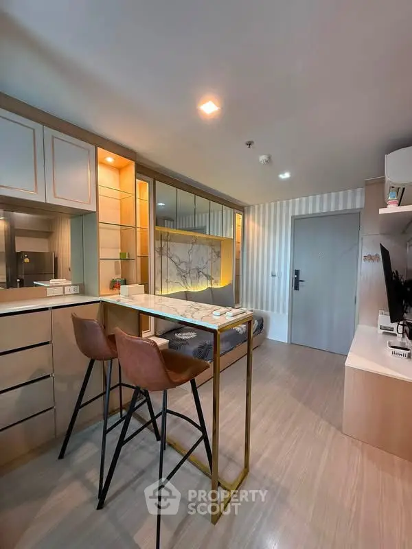 Modern open-plan living area with stylish bar seating and contemporary decor