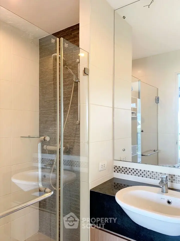 Modern bathroom with glass shower and sleek sink design