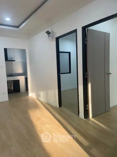 Modern apartment interior with wooden flooring and open kitchen layout