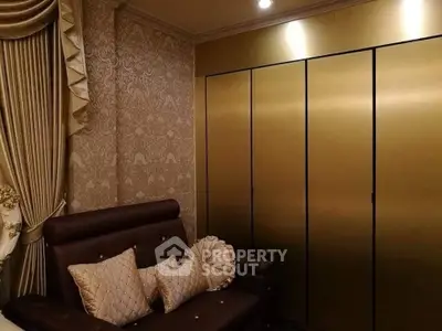 Luxurious living room with elegant wallpaper and plush seating, perfect for sophisticated gatherings.