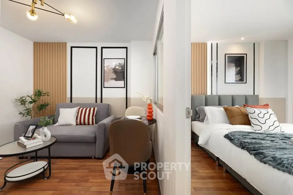 Modern studio apartment with stylish decor, featuring a cozy living area and comfortable bedroom.