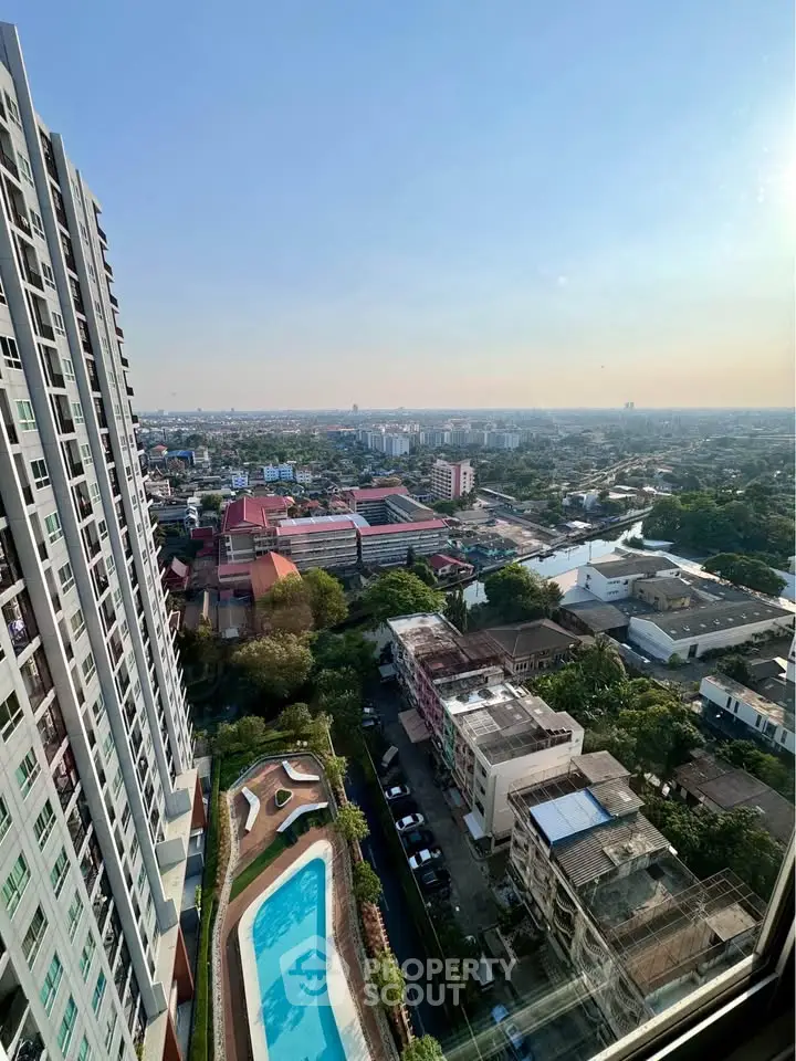 Stunning high-rise apartment view with pool and cityscape, perfect for urban living.