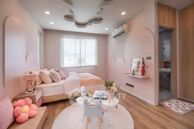 Charming pink-themed bedroom with cozy decor and modern design.